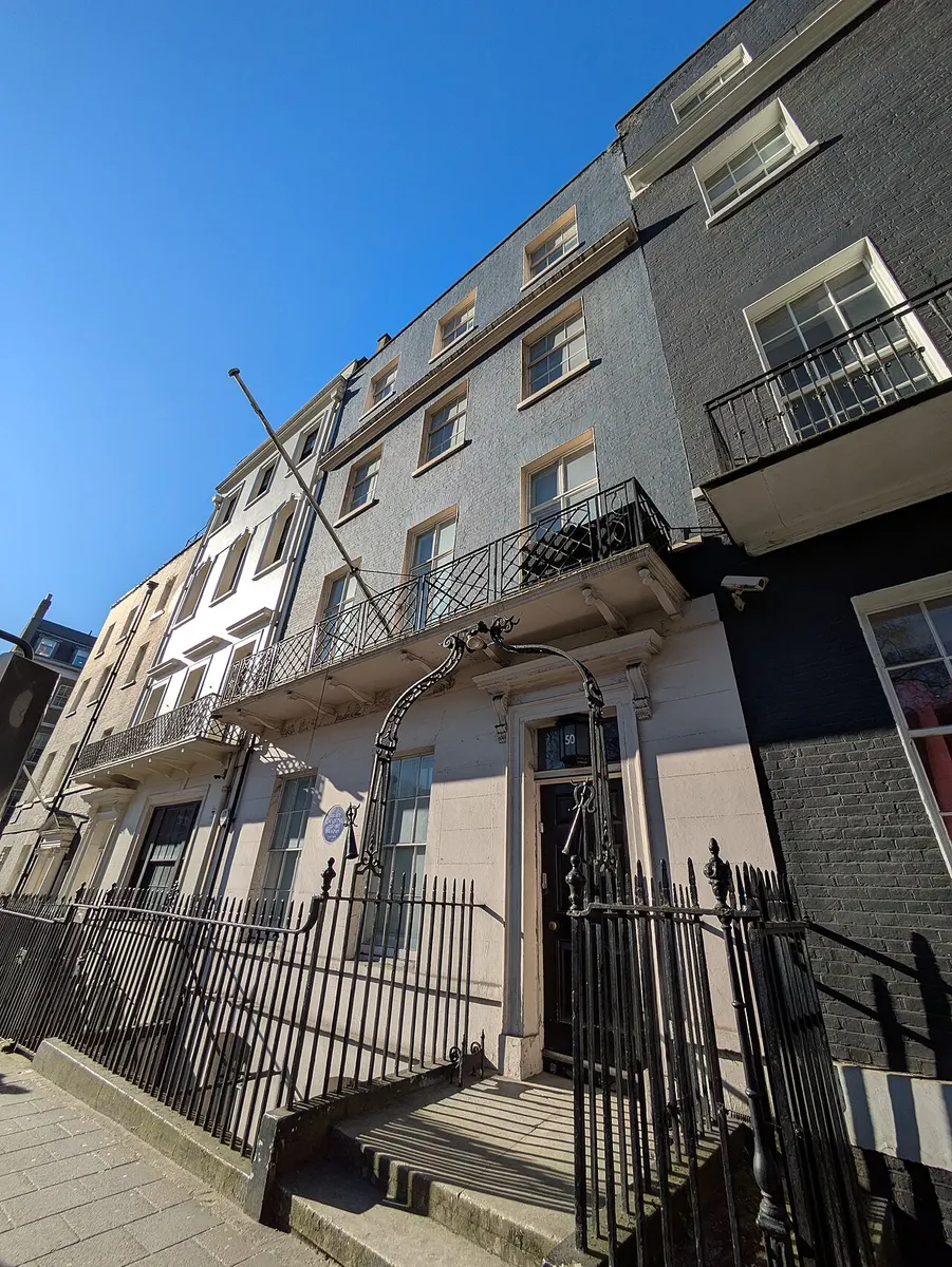 The plain brick Georgian facade of 50 Berkeley Square in Mayfair