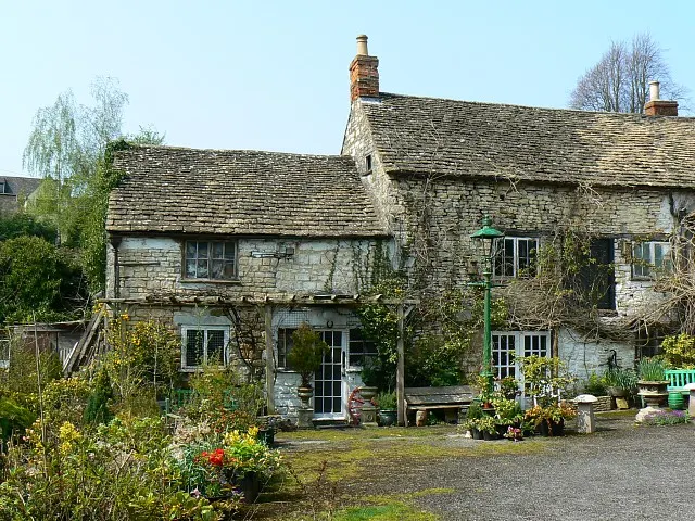The Ancient Ram Inn, a low, crooked old stone and timber building at Potters Pond, Wotton-under-Edge