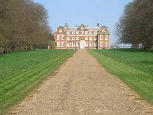 Raynham Hall, a symmetrical 17th-century country house, seen at the end of a long avenue