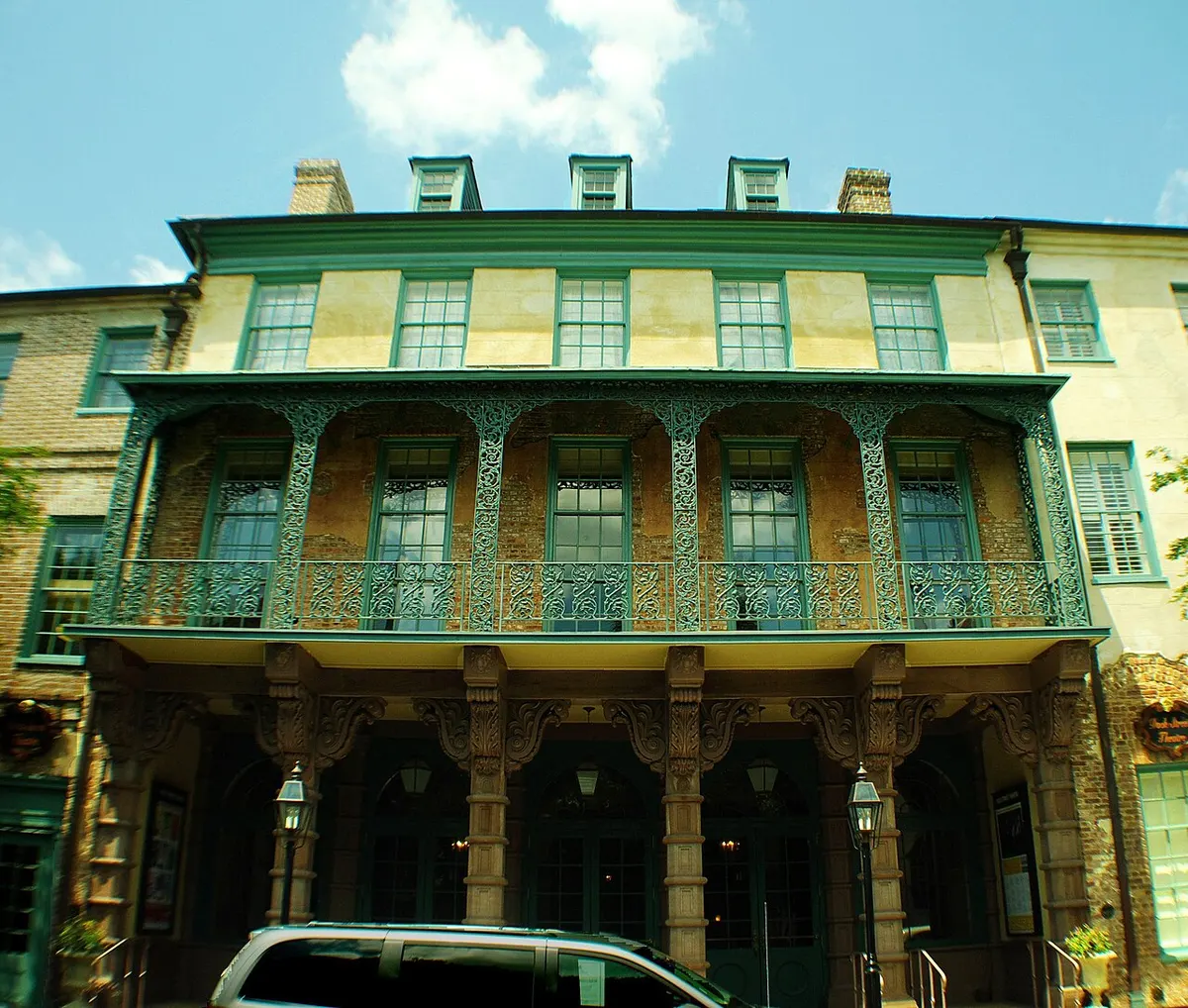 The Church Street façade of the Dock Street Theatre with its iron balcony and sandstone columns