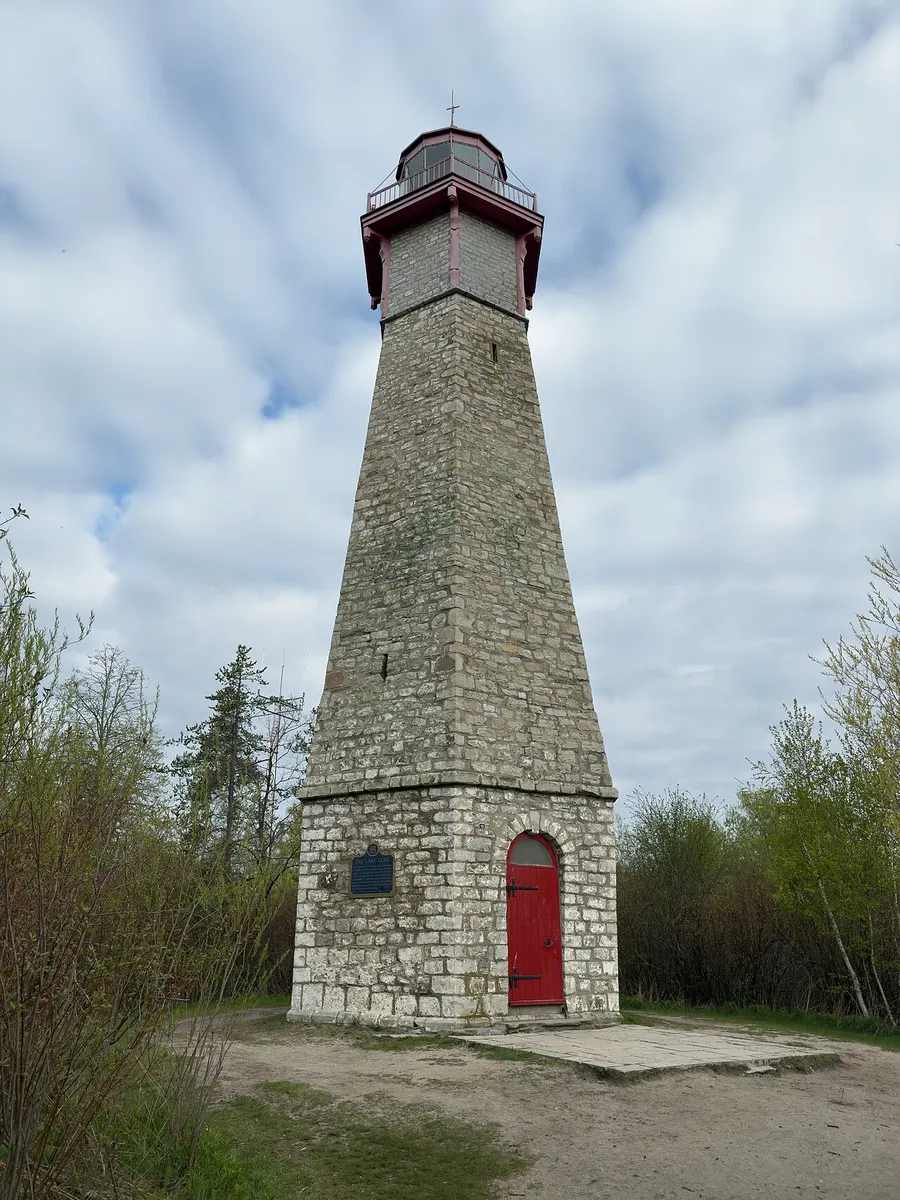 The white hexagonal stone tower of the Gibraltar Point Lighthouse among trees on the Toronto Islands