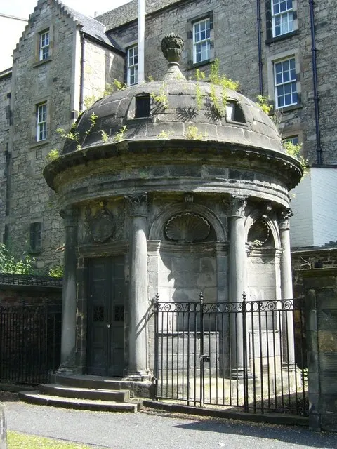 The round, domed stone mausoleum of Sir George Mackenzie among the graves of Greyfriars Kirkyard