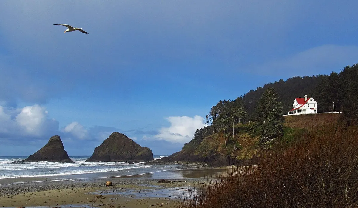 The white Queen Anne-style keepers’ house at Heceta Head above the Pacific
