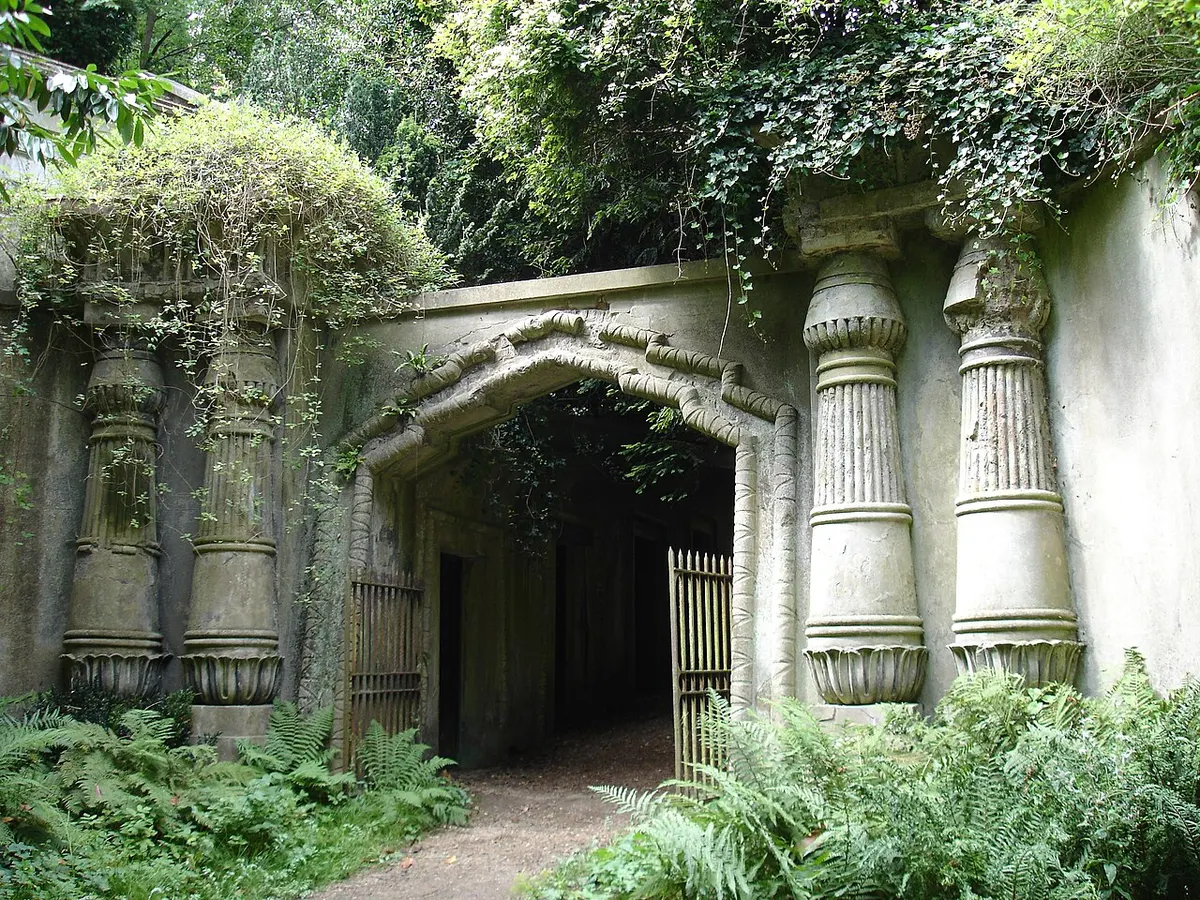 The Egyptian-style stone gateway to the Egyptian Avenue in Highgate West Cemetery, framed by trees