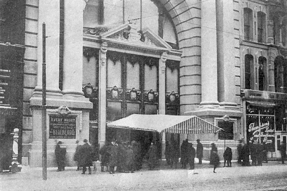 Crowds outside the entrance of the Iroquois Theatre in Chicago with a poster for Mr. Bluebeard