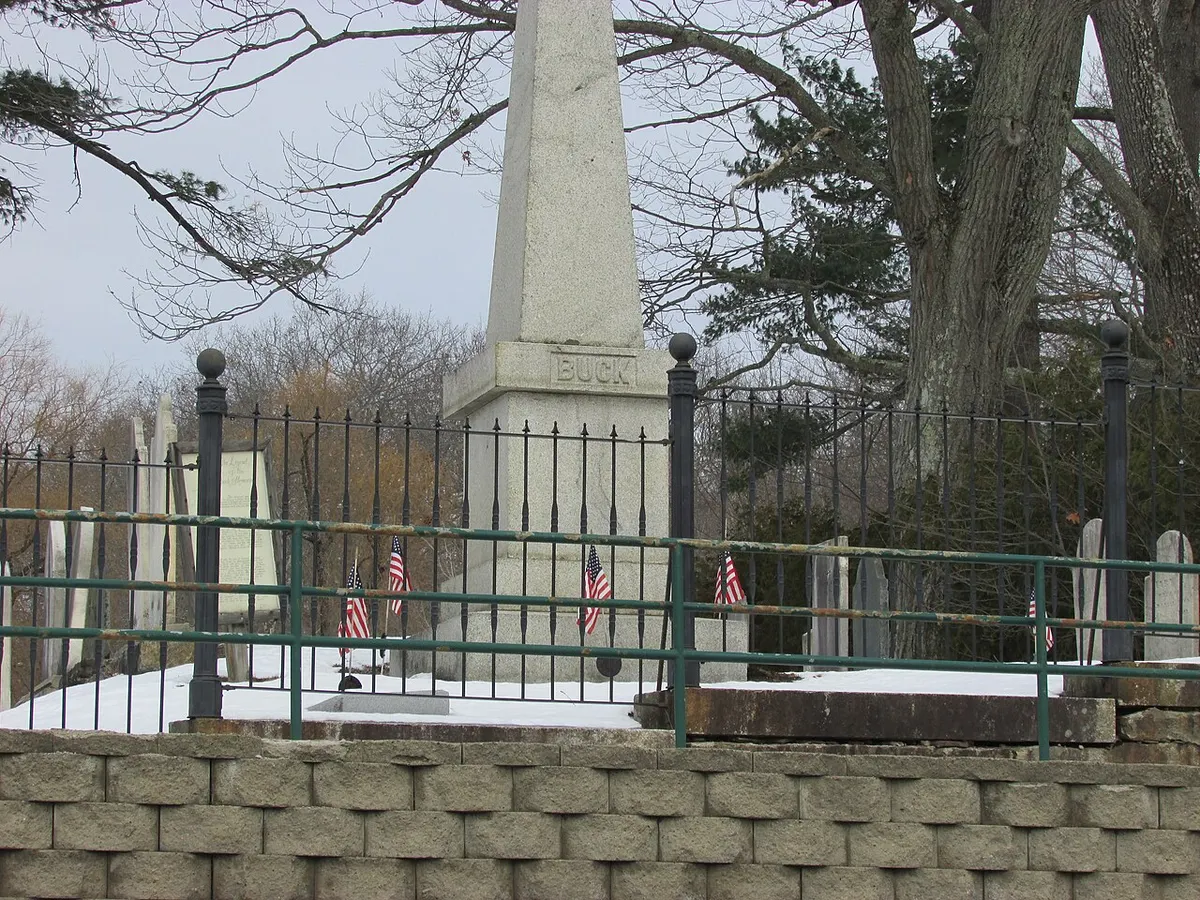 Close view of the granite obelisk to Colonel Jonathan Buck in Bucksport, Maine, with its leg-shaped stain
