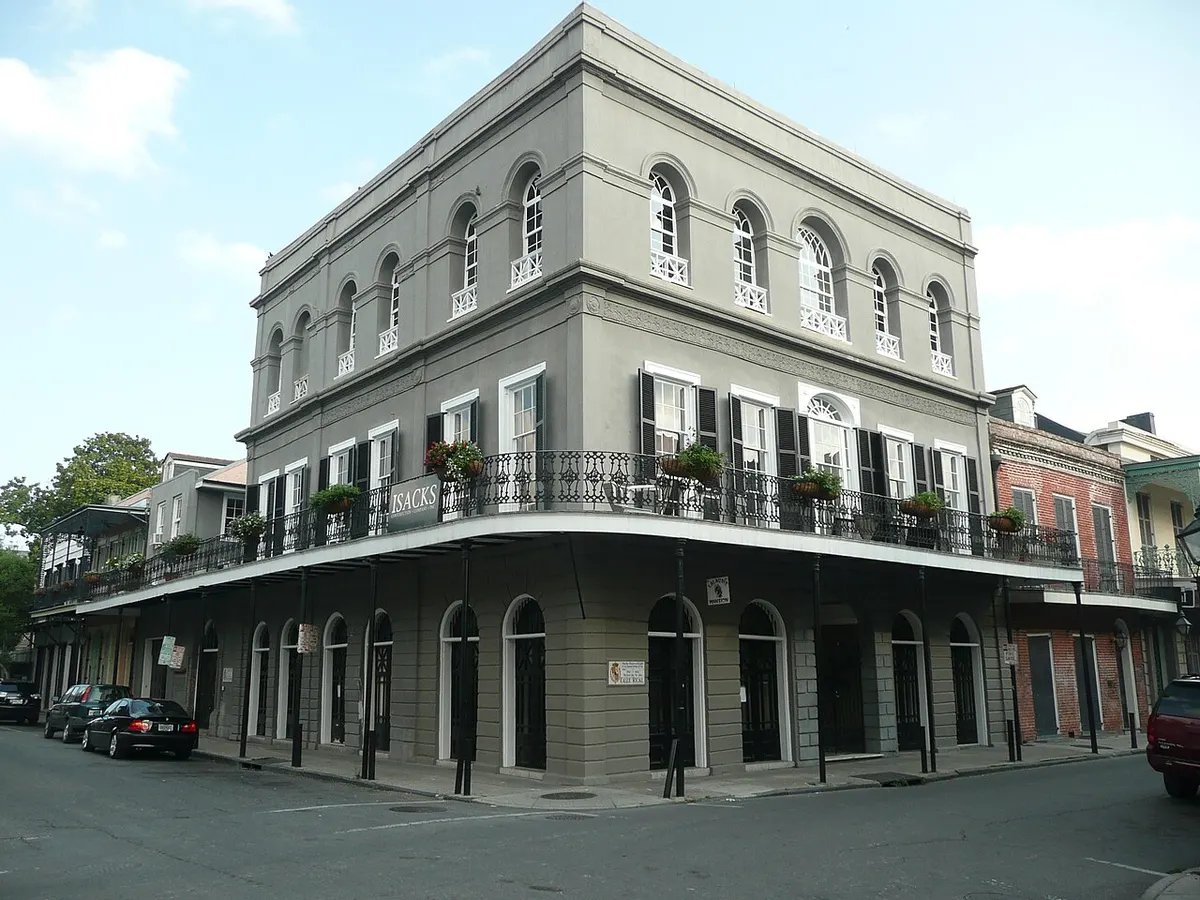 The grey three-storey LaLaurie Mansion with iron balconies on a corner in the French Quarter of New Orleans