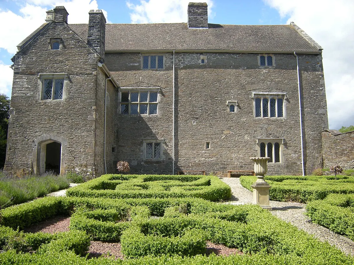 The gray stone Tudor manor house of Llancaiach Fawr with its gardens near Nelson, Caerphilly