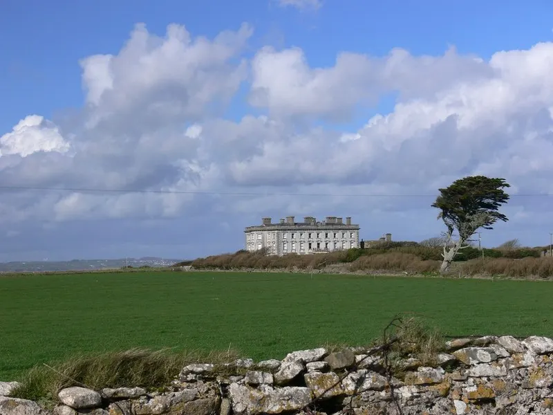The long gray facade of Loftus Hall under a clear sky on the Hook Peninsula