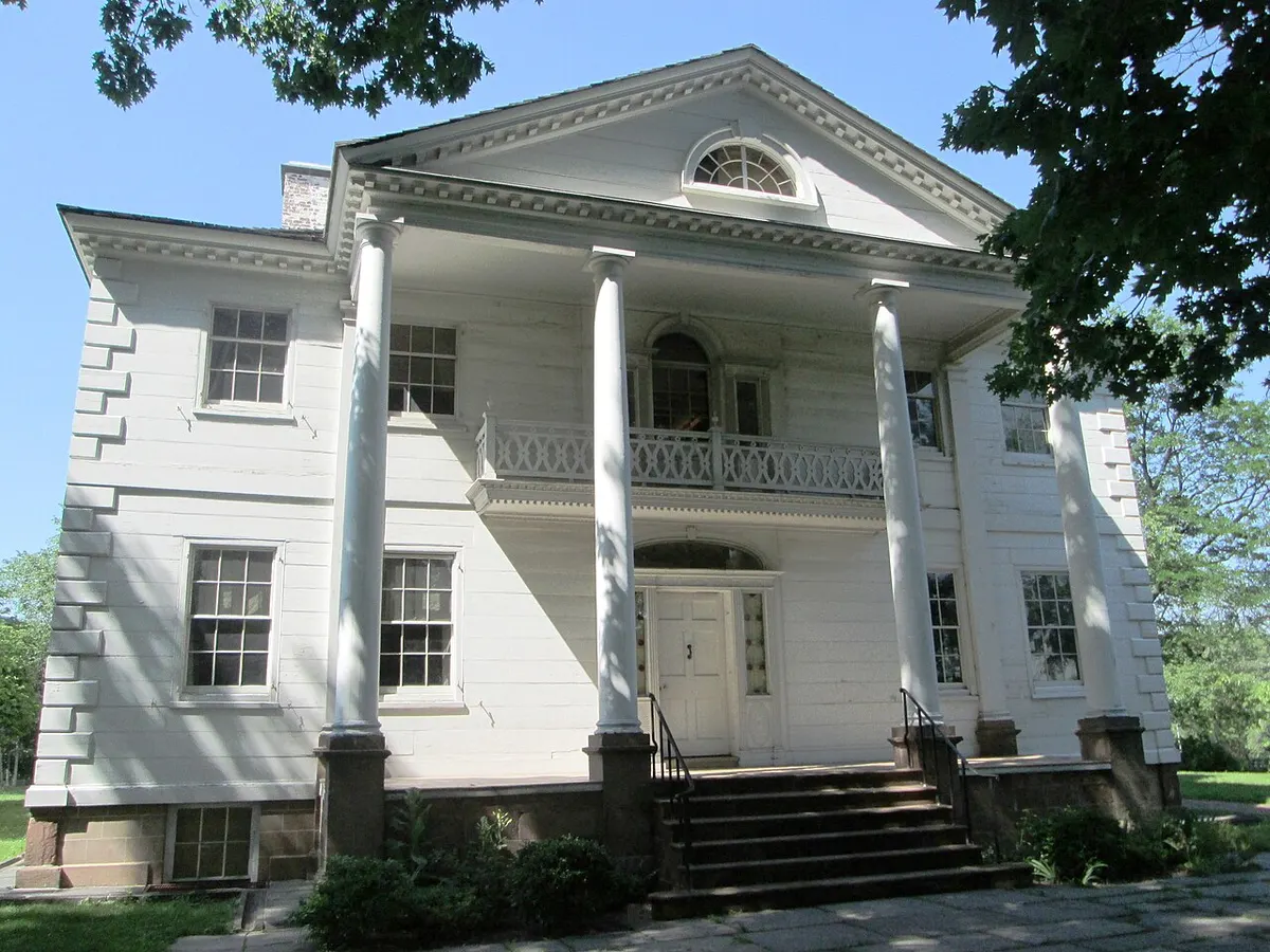 The white Palladian Morris-Jumel Mansion with its columned portico in Washington Heights
