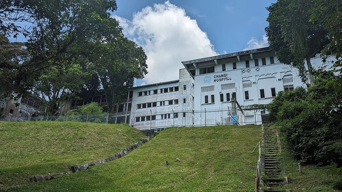 The disused blocks of the former Changi Hospital among trees on a hill in Changi, Singapore