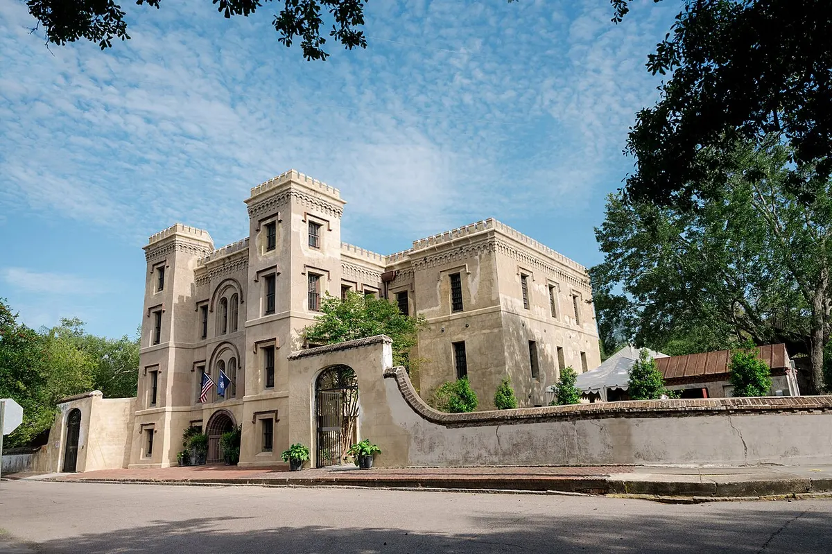 The battered stone façade of the Old Charleston Jail on Magazine Street