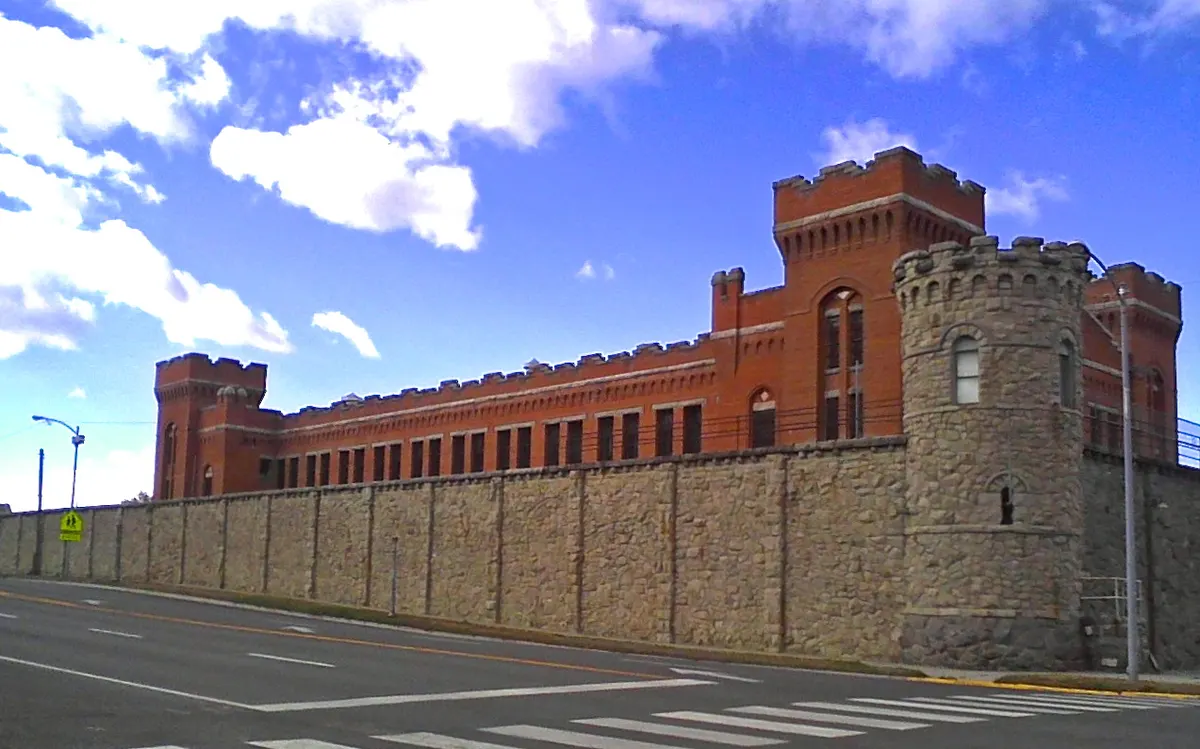Sandstone walls and a corner guard tower of the Old Montana State Prison in Deer Lodge
