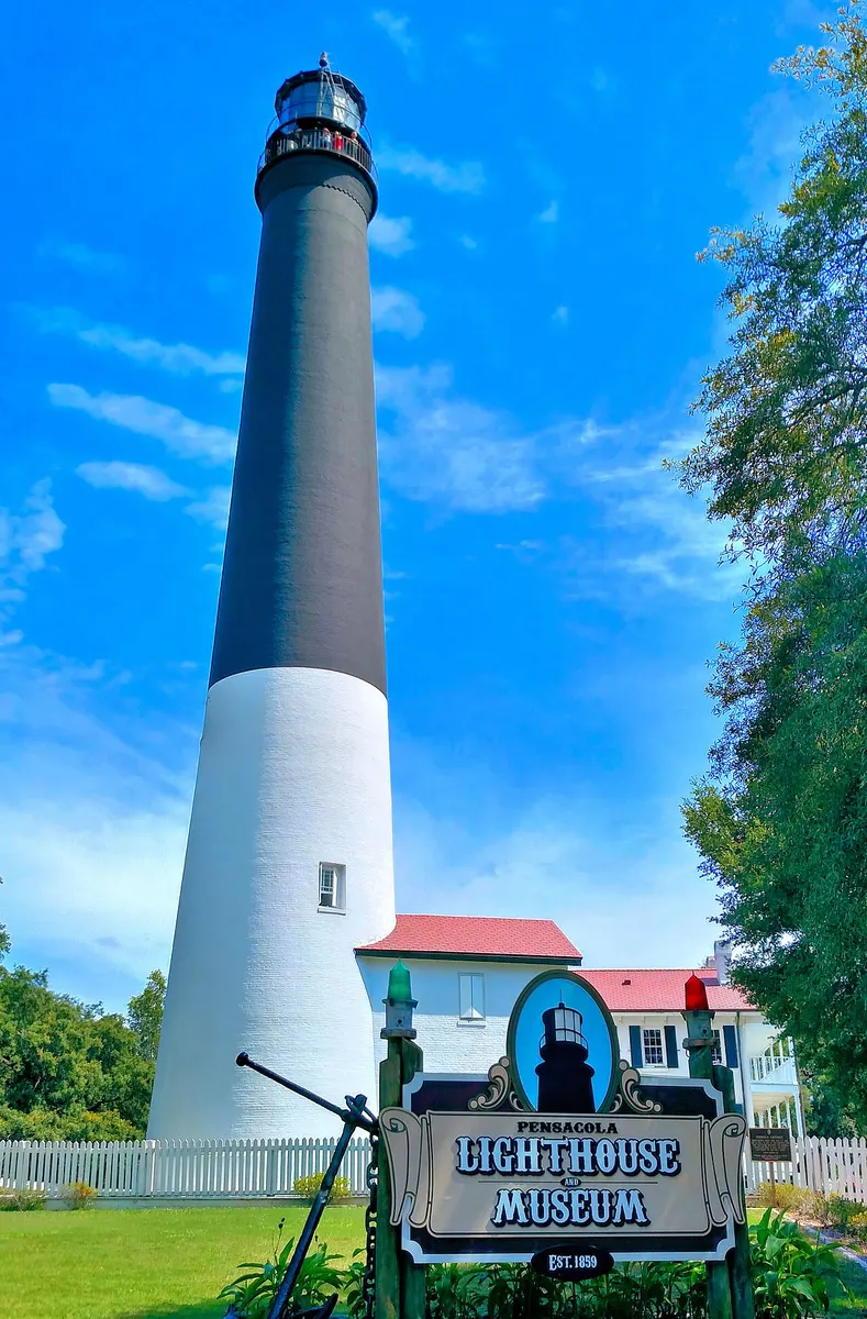 Pensacola Light, a tall black-and-white brick lighthouse, in July 2017