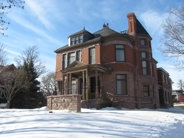 The Pettigrew Home & Museum, a red-brick and pink quartzite Queen Anne house in Sioux Falls, in winter