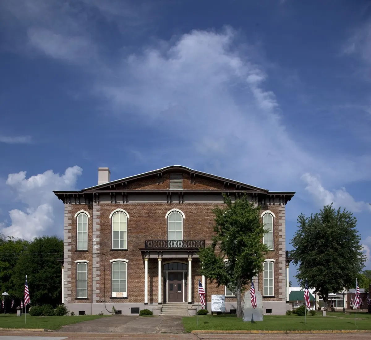 The brick Pickens County Courthouse in Carrollton, Alabama, with its clock tower and upper windows