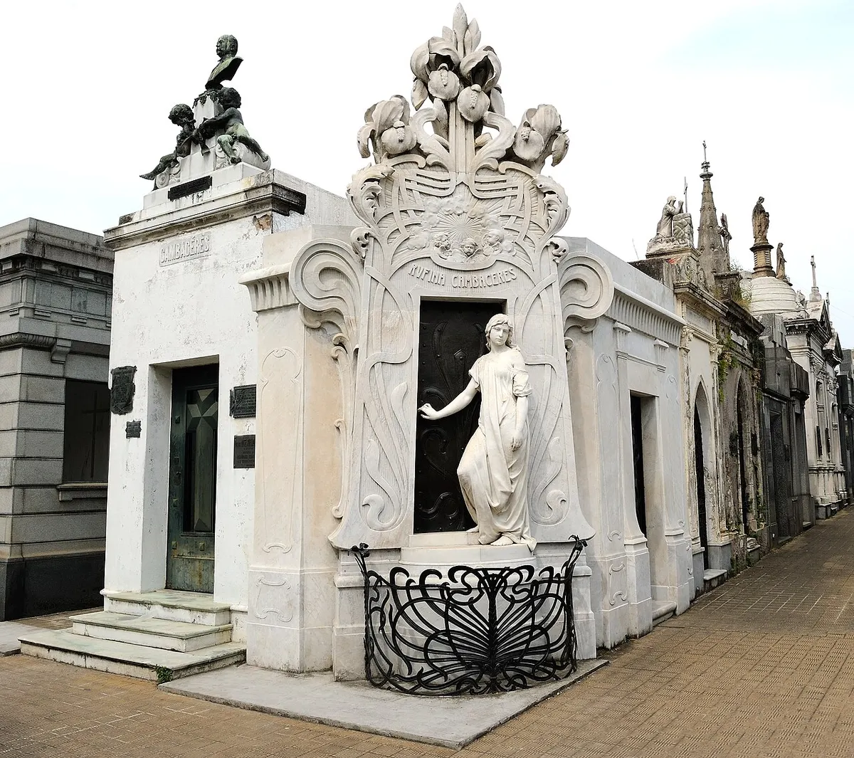 The Art Nouveau tomb of Rufina Cambacérès with a marble statue of a young woman at its door