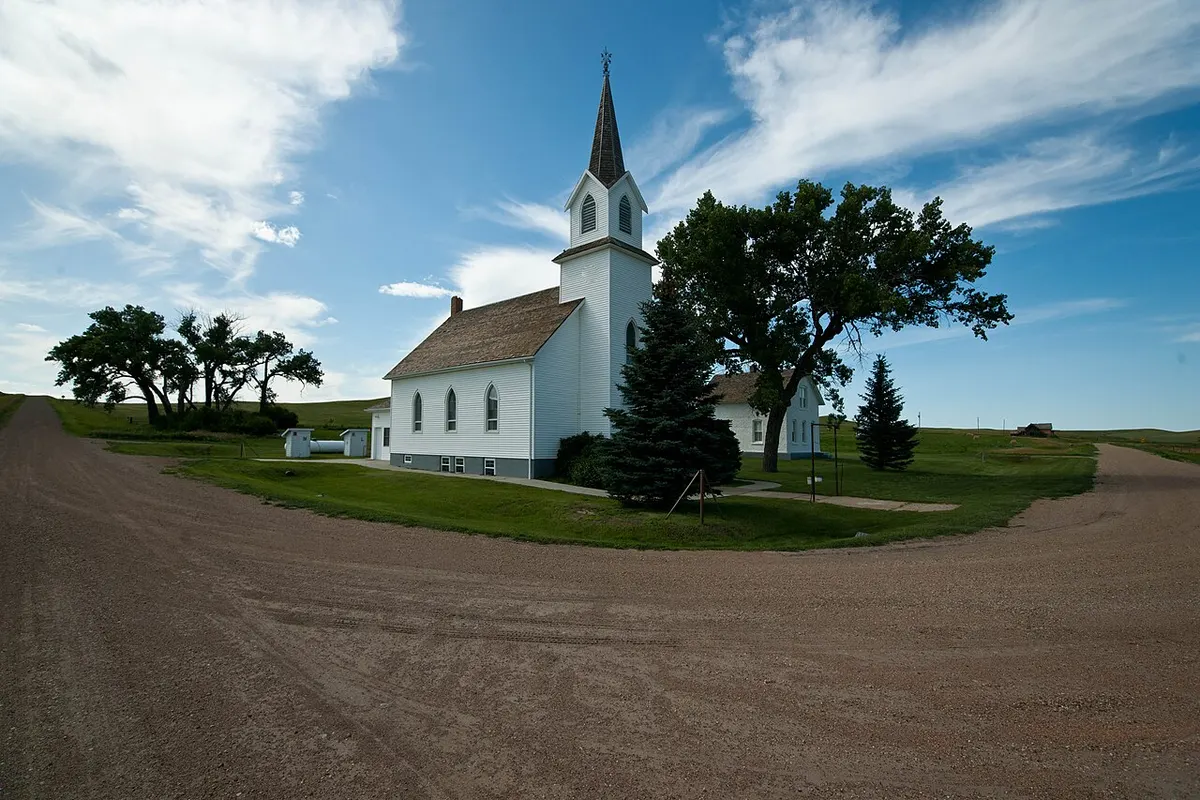 The white Sims Scandinavian Lutheran Church on the prairie
